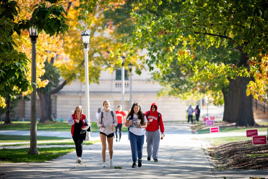 four college students walking