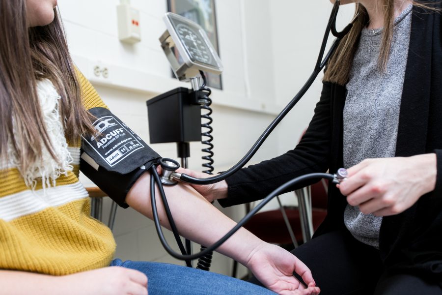 a patient getting their blood pressure checked