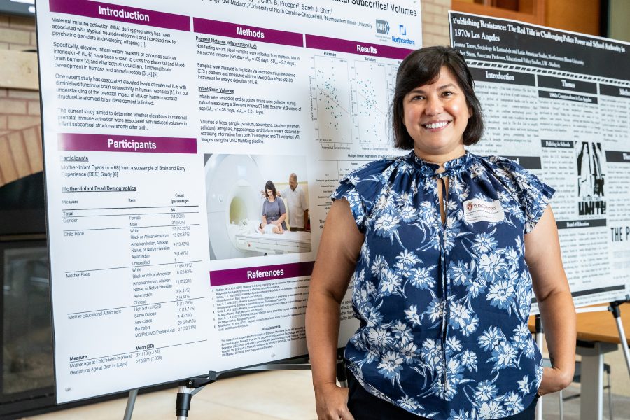 Christina Anne Esparza-Cassidy stands next to a SERP research poster.