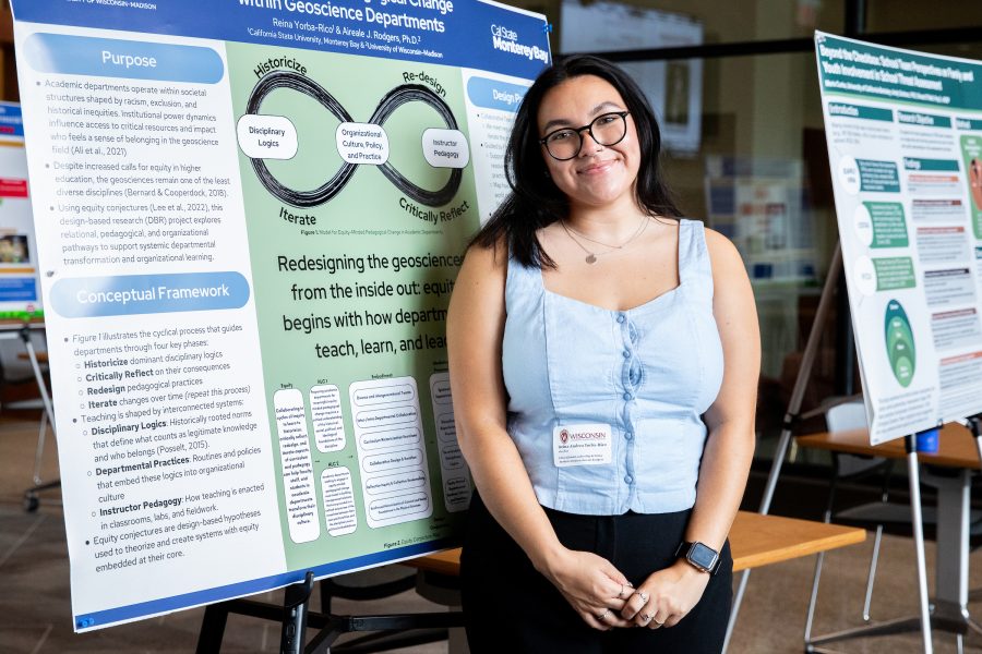 Reina Andrea Yorba-Rico stands in front of a SERP research poster.
