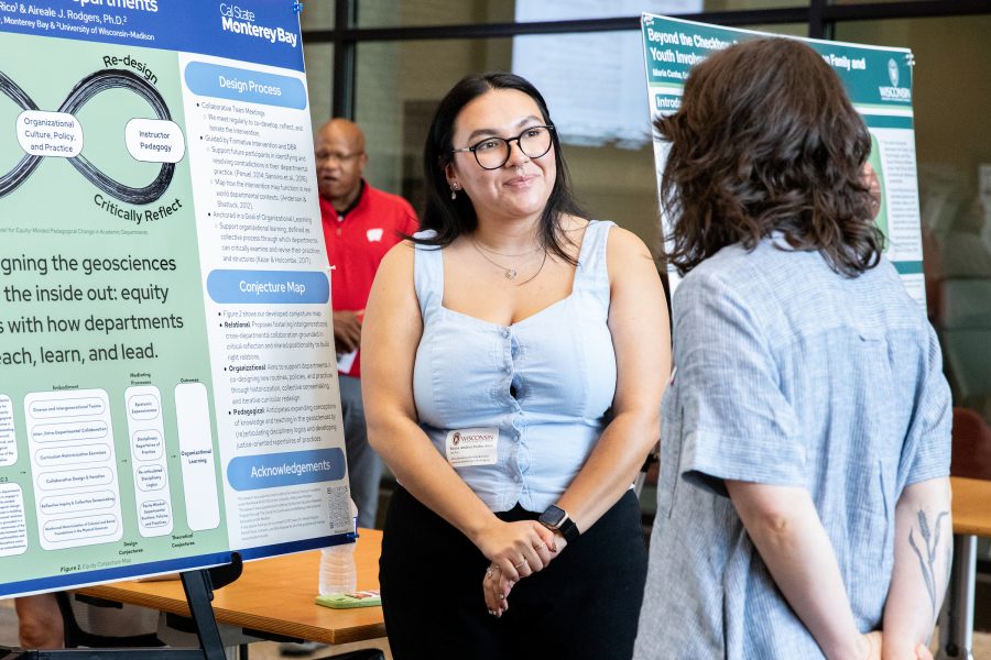 student presenting research to a group at a poster fair