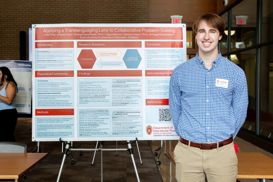 Collin Pitts stands next to a SERP research poster.