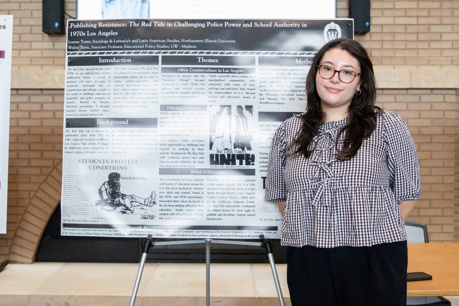 Joanna Elizabeth Torres stands in front of a SERP research poster.
