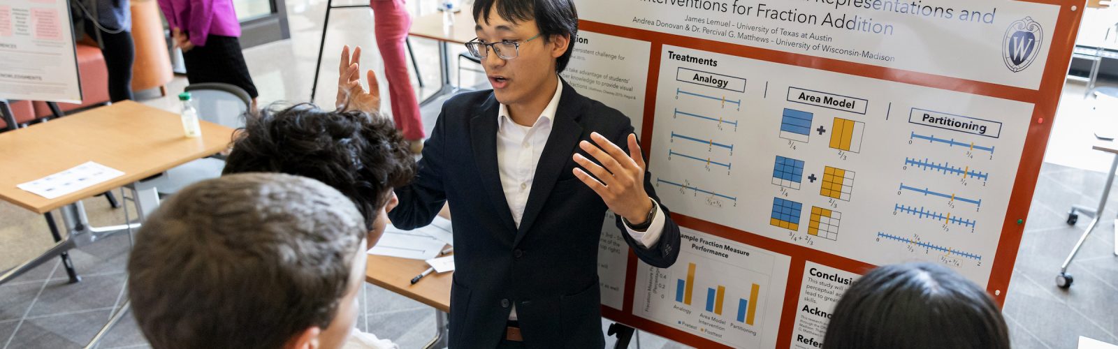student presenting research to a group at a poster fair