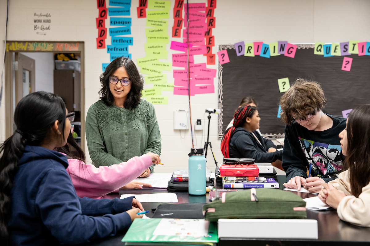woman talks to students in classroom