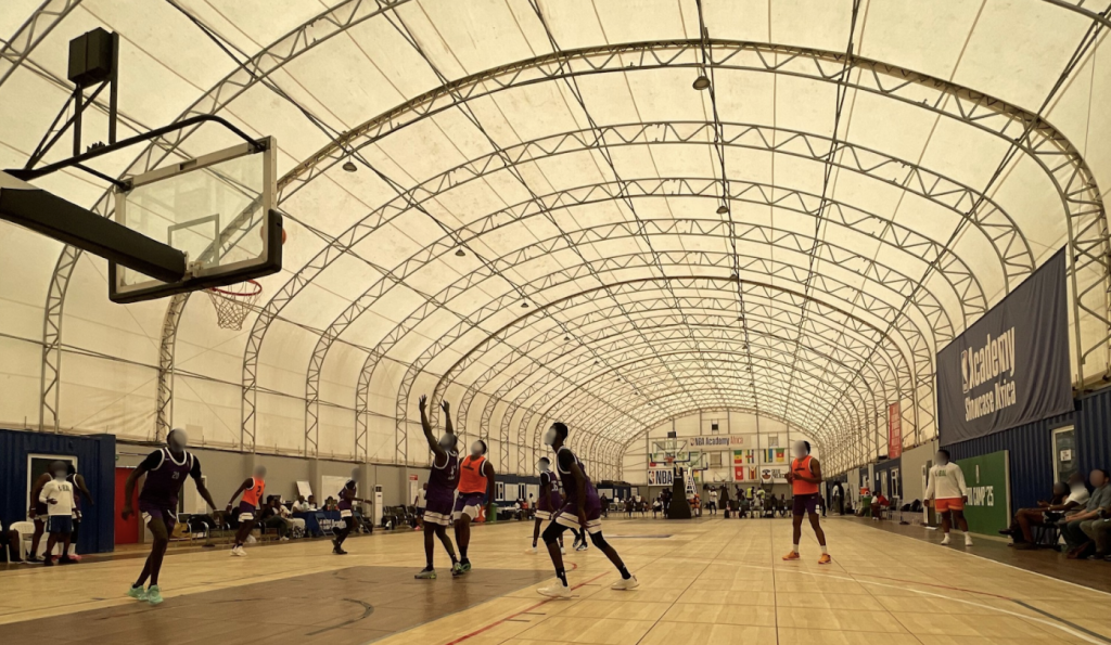 several young men play basketball