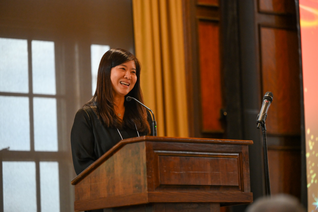 a woman smiles at a podium