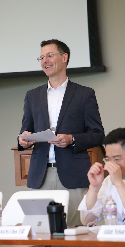 Adam Nelson smiles and speaks at the UW-PKU Workshop.