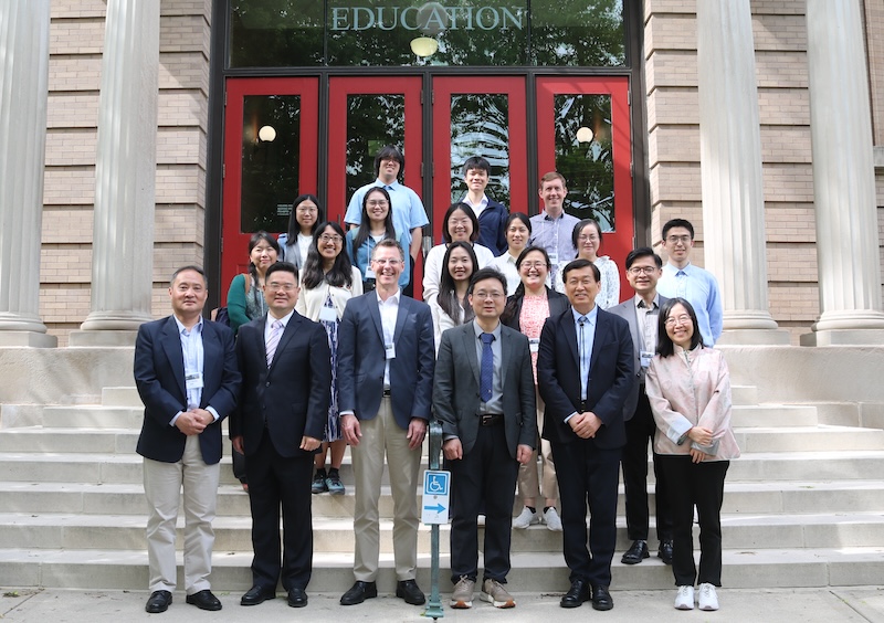 Photo of participants in this spring's UW-PKU Workshop standing in front of the red doors of the Education Building on the UW-Madison campus.